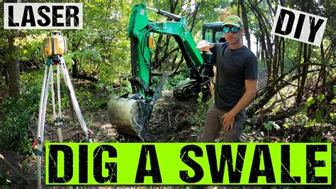 dig a swale with a mini excavator|bobcat swale diy.